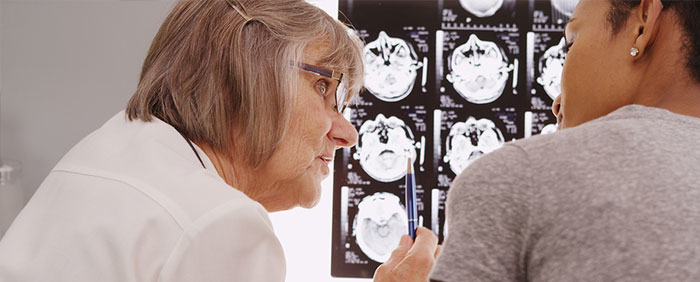 Mature Radiologist Reviewing X-ray Results With Patient