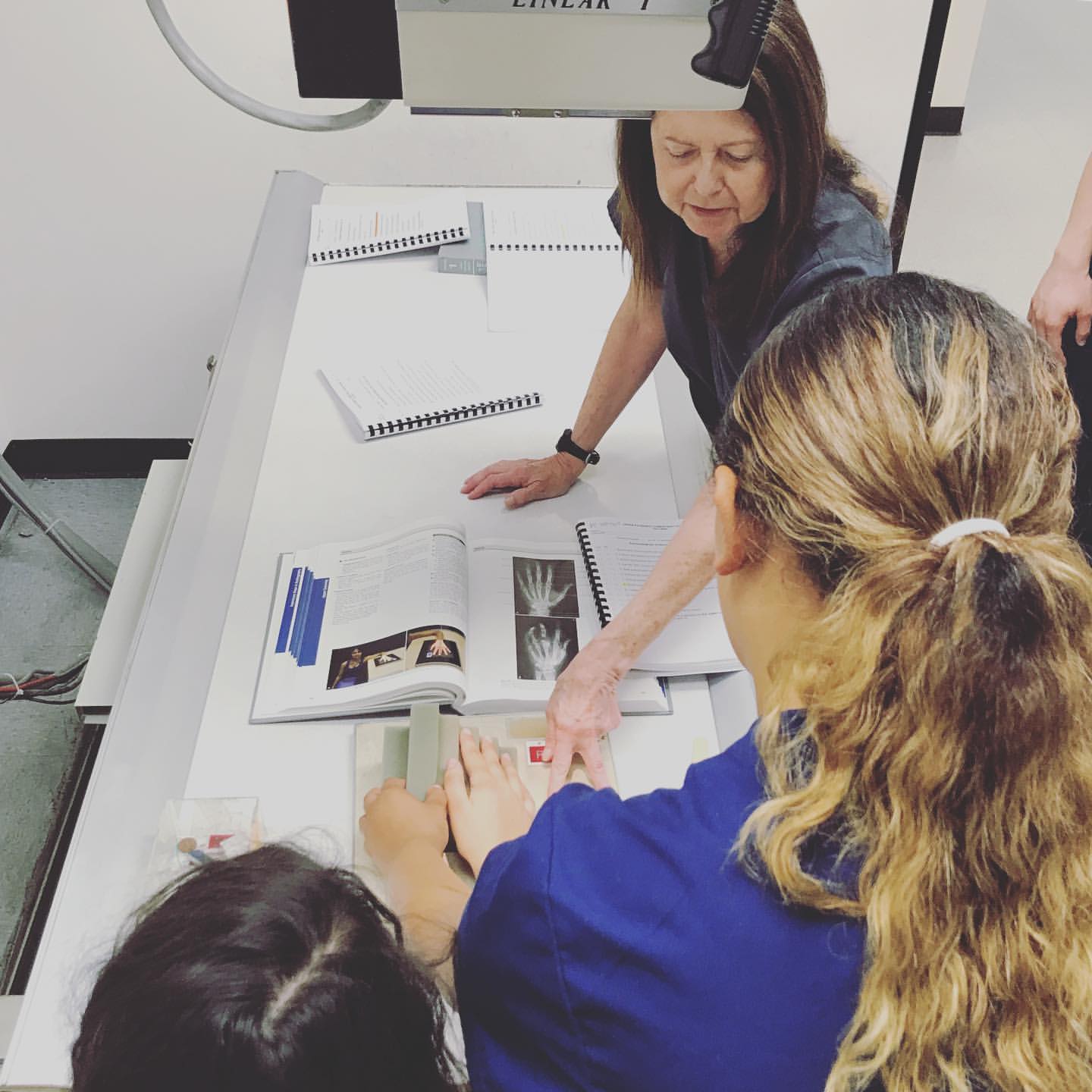 Students in our evening X-ray Technician class work alongside their experienced instructor.