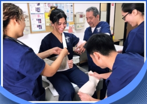 Students work on their first-aid and BLS bandaging skills in Modern Technology School's Medical Assistant Program in Orange Conty